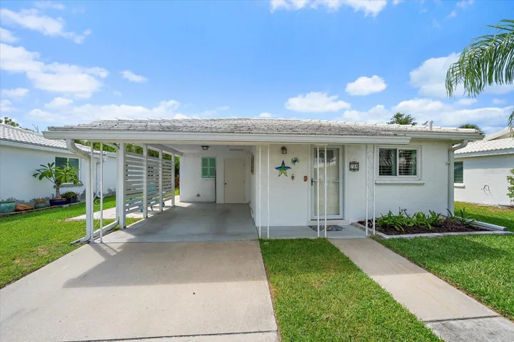Front Covered entry and carport with landscaped walkway
