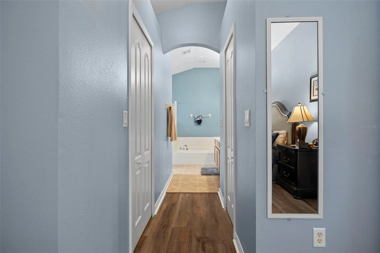 His and hers walk-in closets lead to the primary bathroom