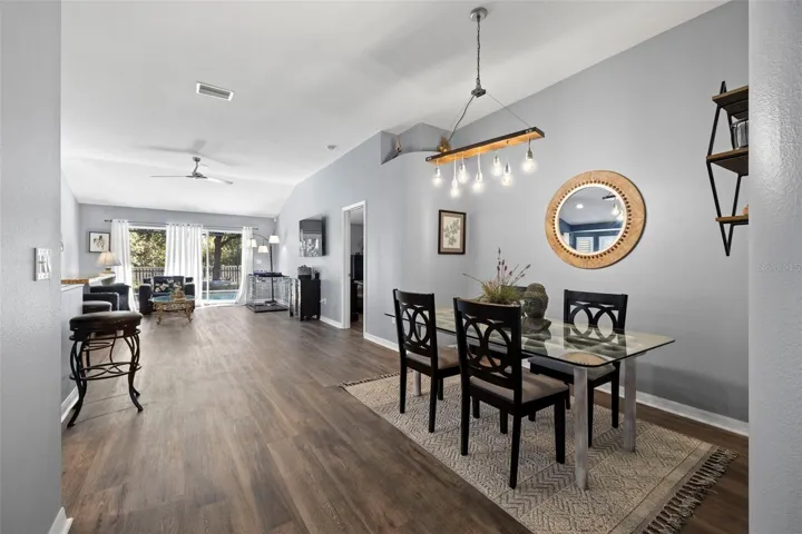 An open floor plan greets you with a dining area, living room and kitchen with access to the pool, pond views and conservation.