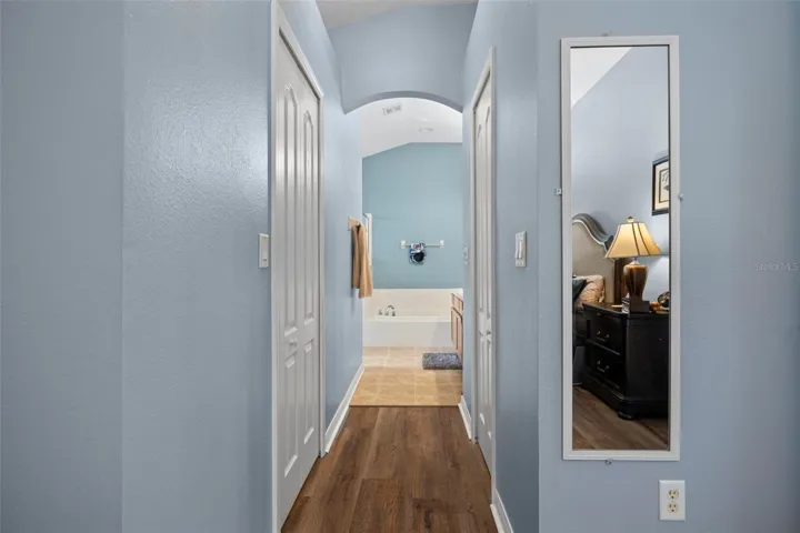 His and hers walk-in closets lead to the primary bathroom