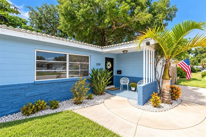 Welcoming front porch to this ranch style home  and timeless Florida curb appeal