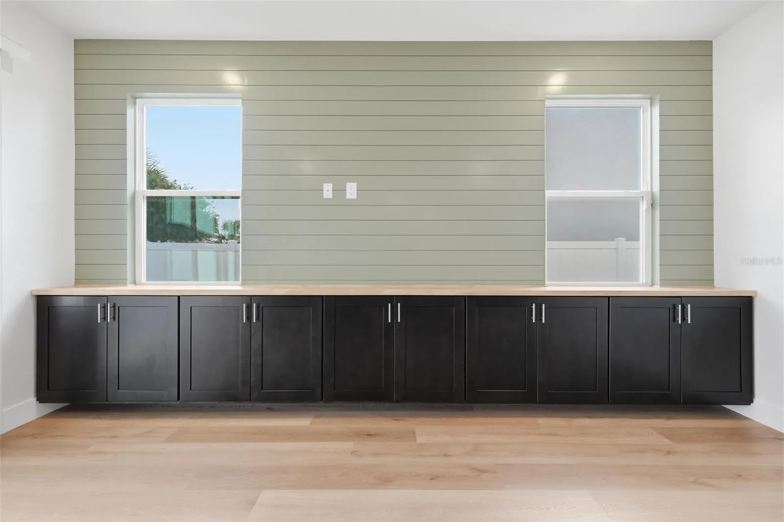 Custom built-ins and shiplap accent wall in the living room