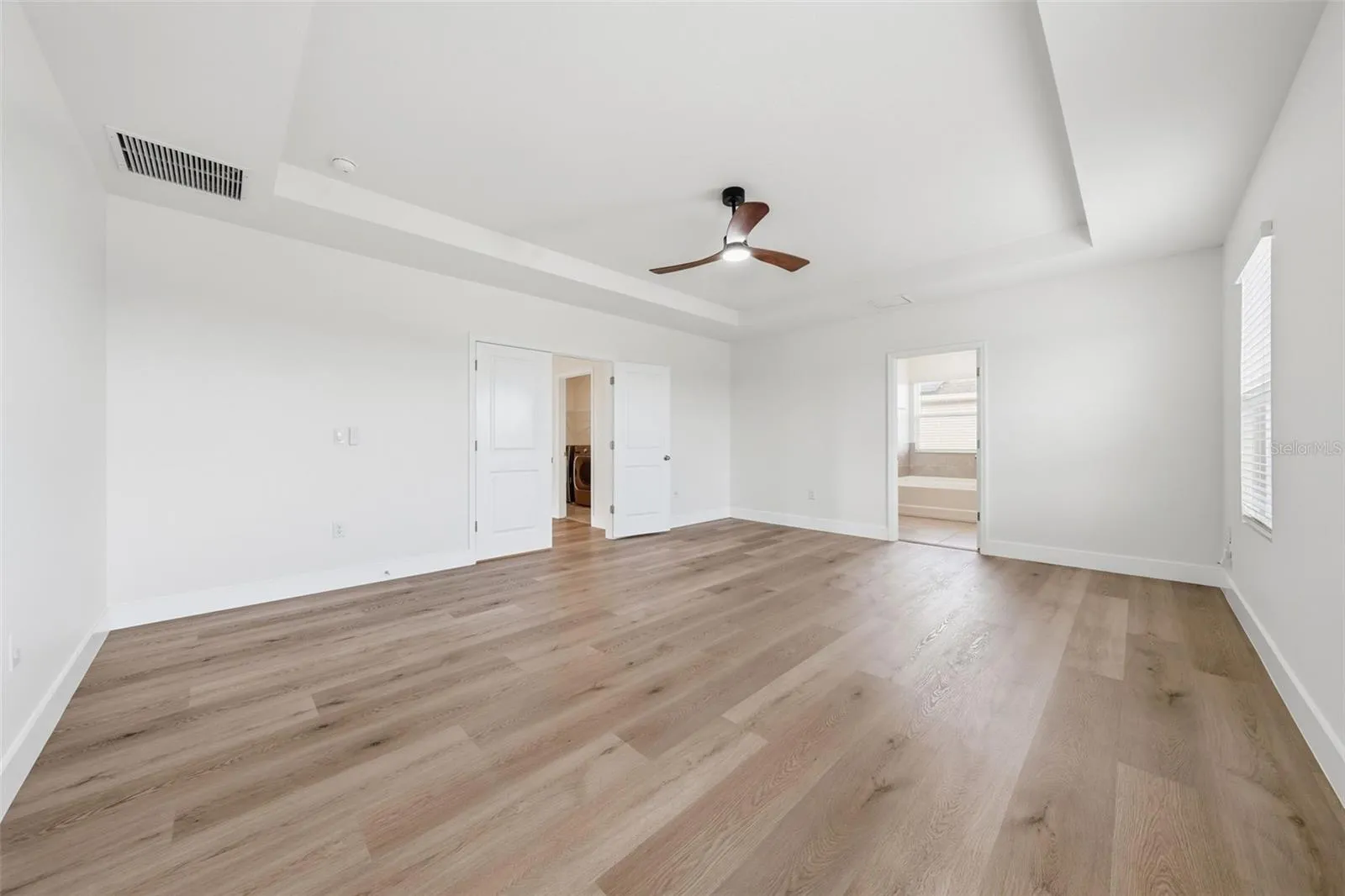 Primary bedroom with french door entry and room for a sitting area