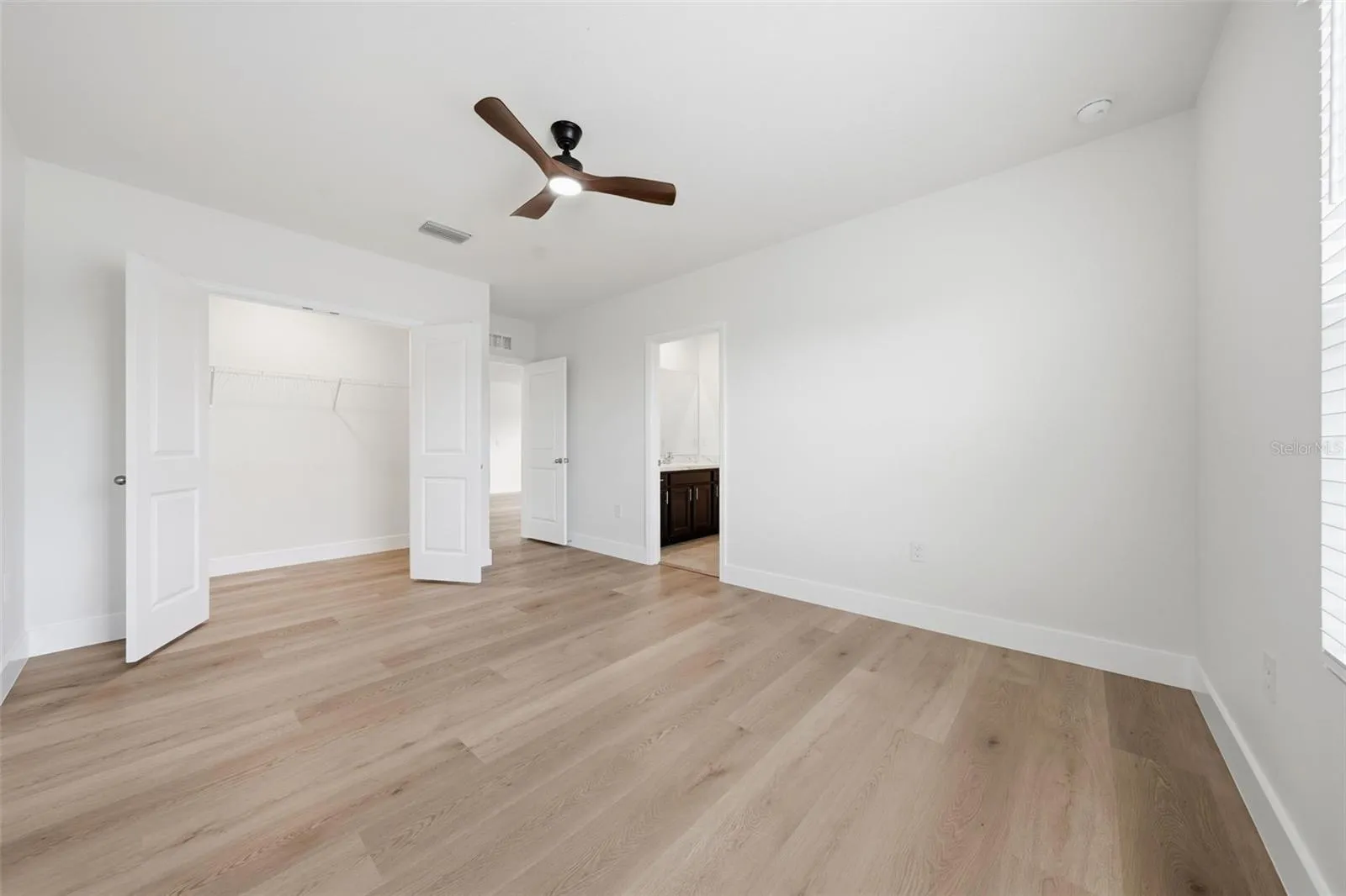 Upstairs 2nd bedroom with new LVP and ceiling fan