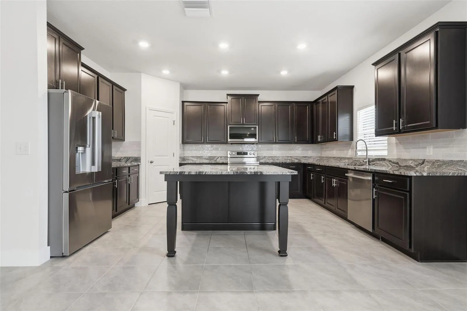Kitchen with brand-new LG stainless steel appliances and walk-in pantry