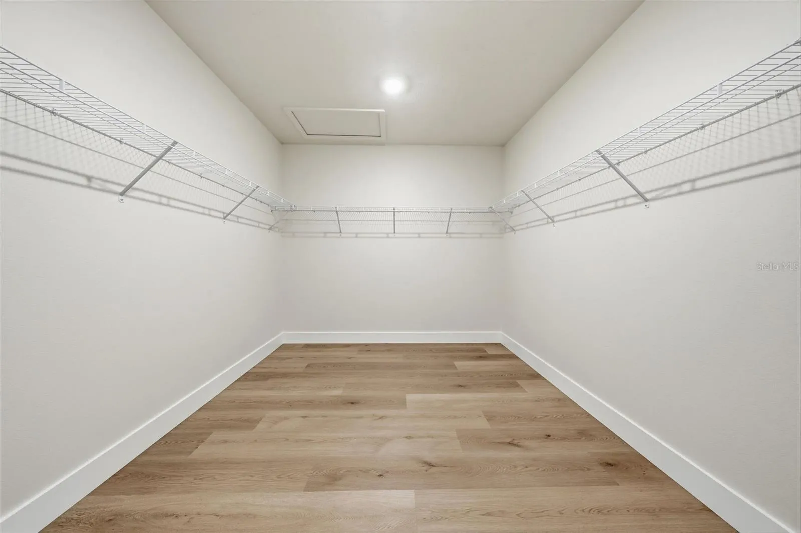 Huge primary walk-in closet ready for custom built-ins