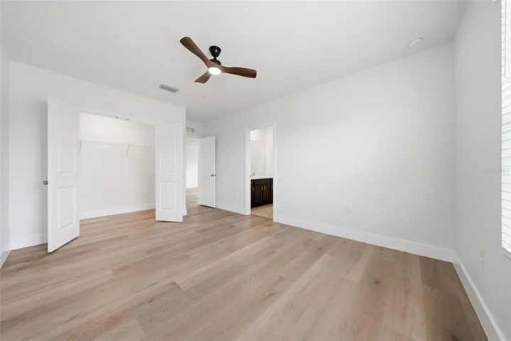 Upstairs 2nd bedroom with new LVP and ceiling fan
