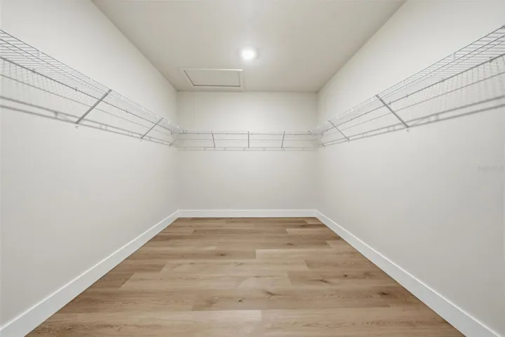 Huge primary walk-in closet ready for custom built-ins