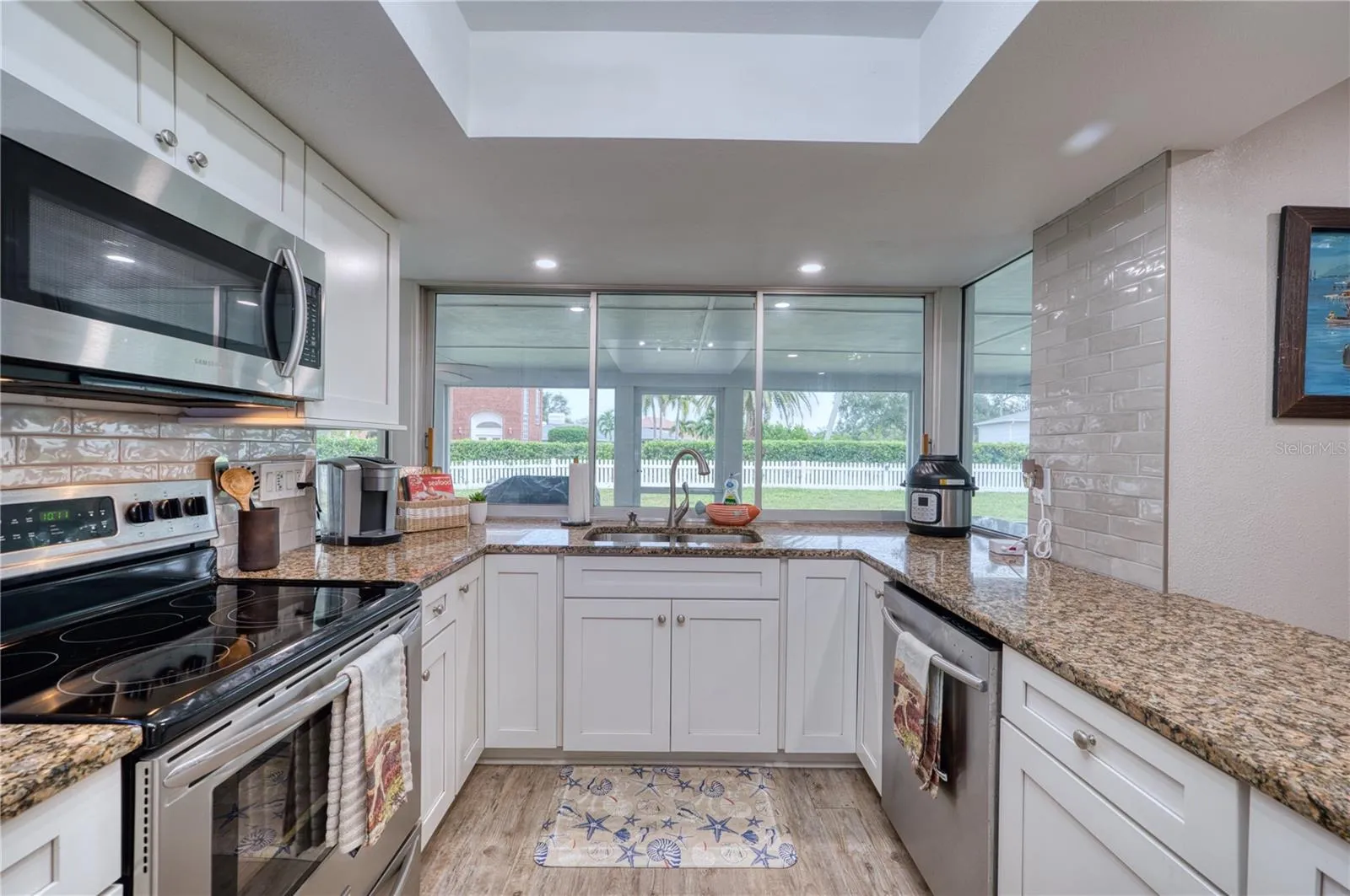 Kitchen with window sliders to the bar on the back lanai