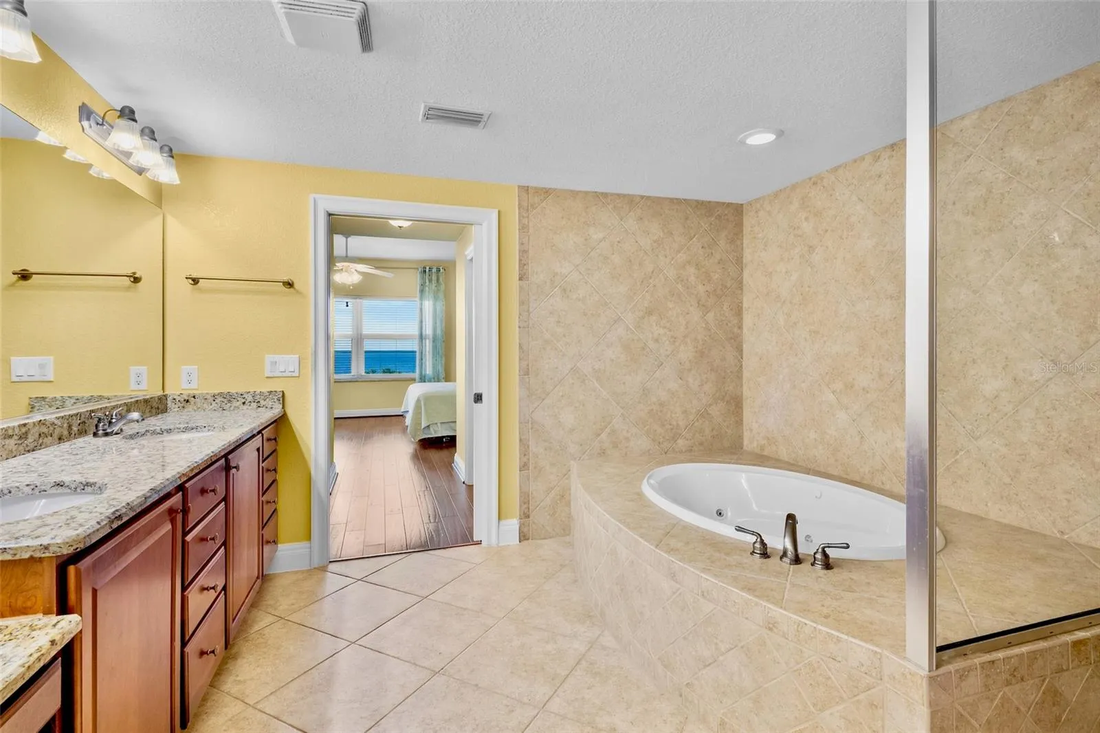 Primary bath with garden tub and walk-in shower.