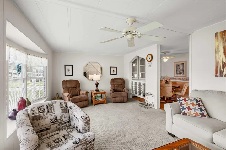 Living room has many double pane windows.
