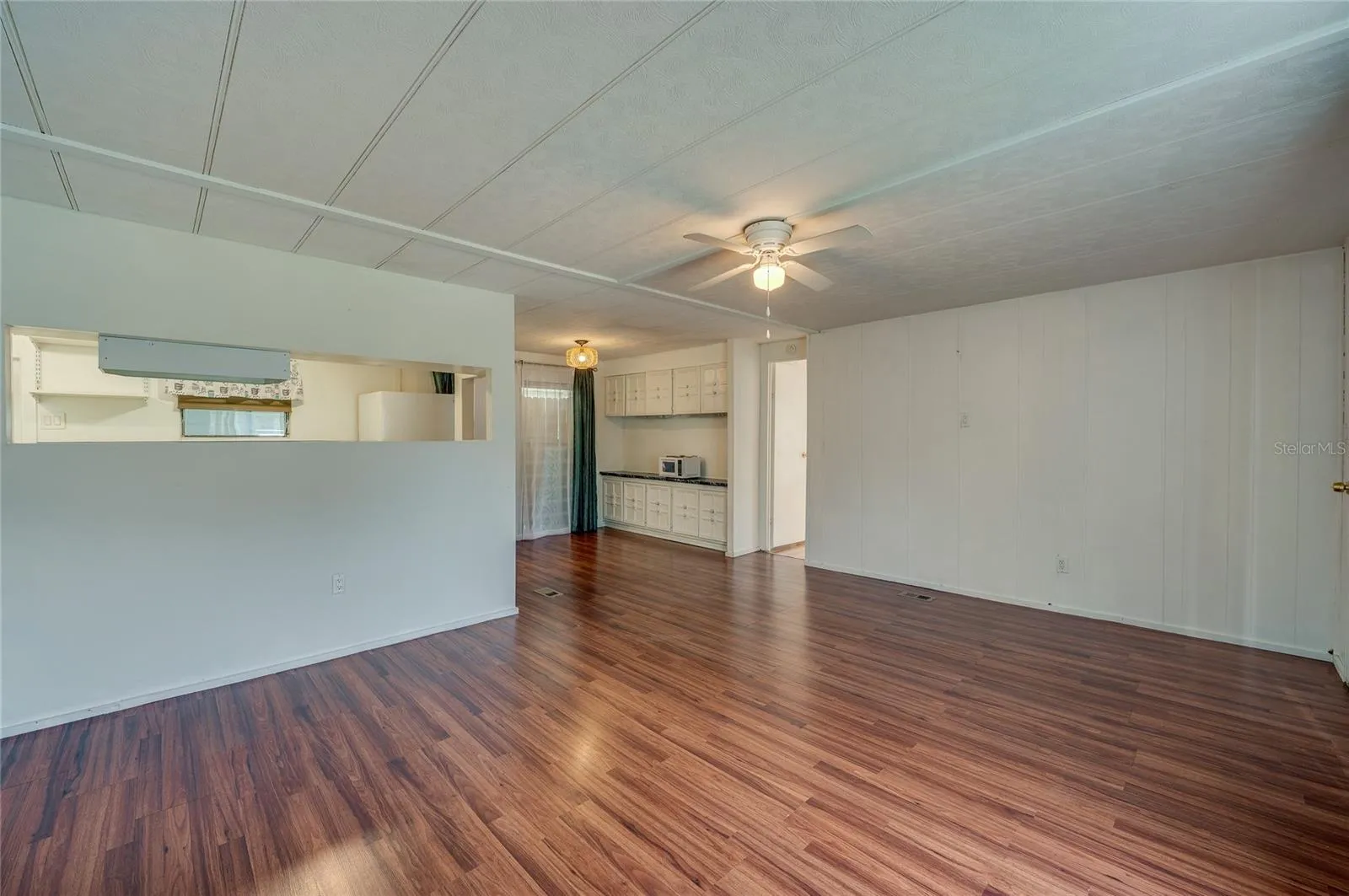 Open and flexible interior layout provides ample room for separate living and dining zones, with a convenient pass-through to the kitchen.