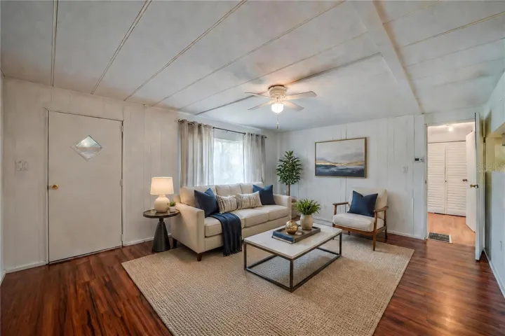 Virtually Staged - Expansive living room offers plenty of flexibility for multiple furniture arrangements, along with a ceiling fan and a large window overlooking the exterior.