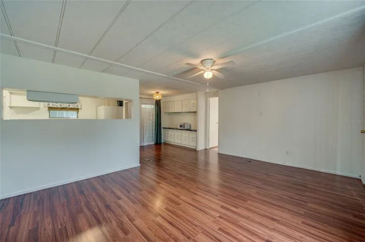 Open and flexible interior layout provides ample room for separate living and dining zones, with a convenient pass-through to the kitchen.