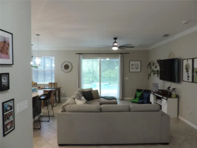 Hallway view of living room out to the pool