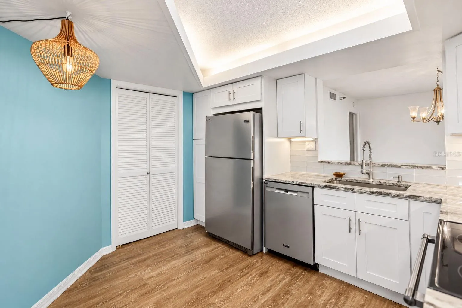Kitchen remodel includes pantry closet and extra pantry next to the refrigerator.