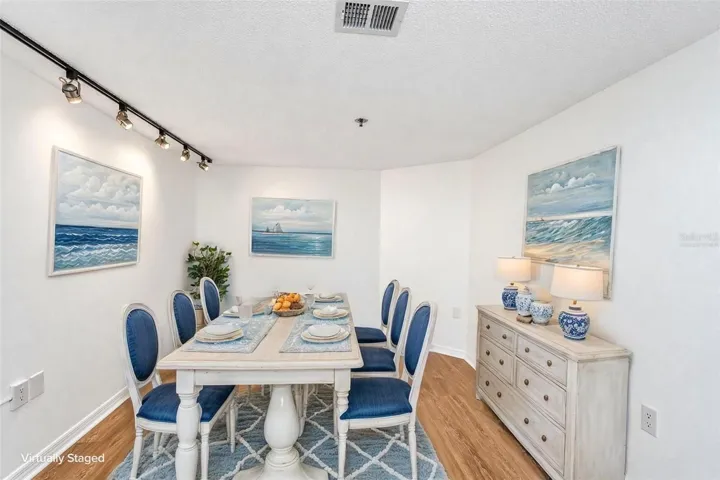 Option 2 for den = dining room furniture virtually staged