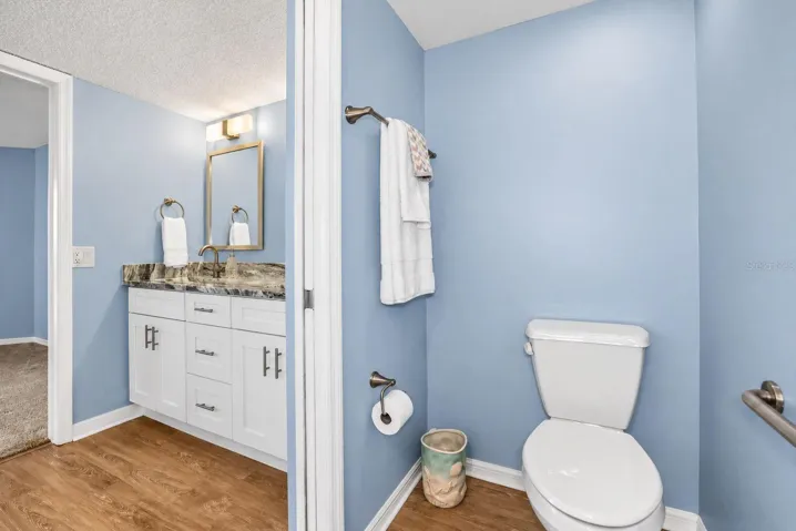 Primary Bathroom, newly updated with double sink shaker cabinet vanity with soft close drawers, lighting, mirrors and paint.