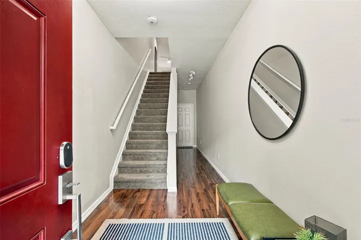 The Foyer - While the Stairs take you up into the condo, they also provide great Extra Storage Underneath! Plus you have Access to the Garage