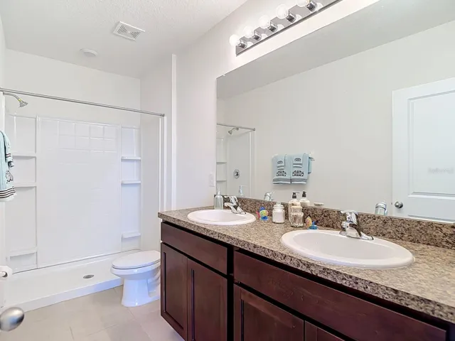 Primary bath  with dual sinks and walk in shower