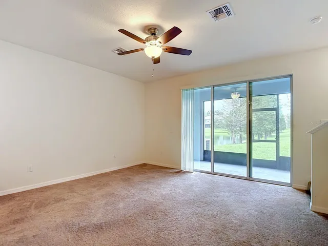 Living area with triple sliding doors to the lanai