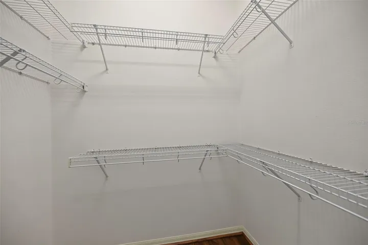 One of two walk-in closets in primary bedroom