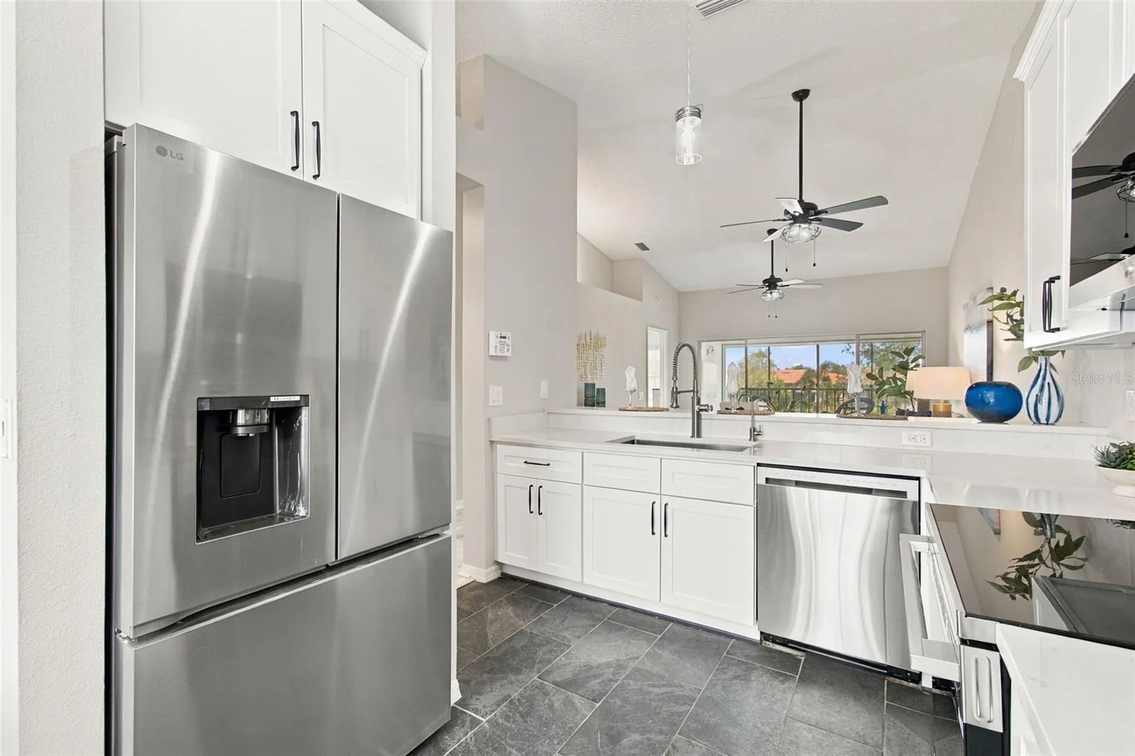 A LOOK FROM KITCHEN INTO LIVING AREA