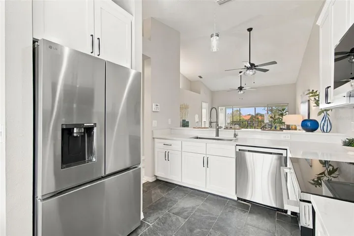 A LOOK FROM KITCHEN INTO LIVING AREA
