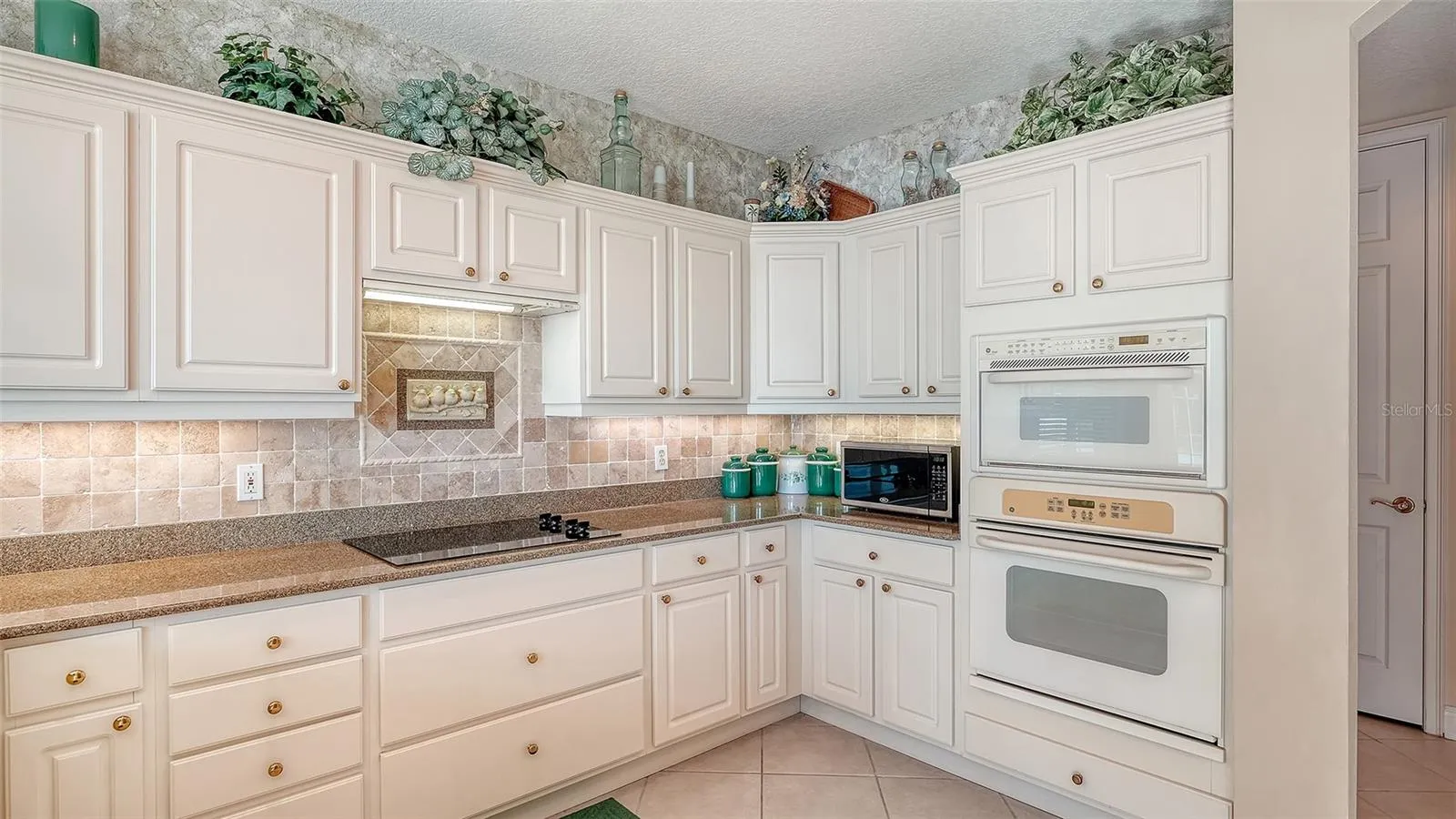 Large kitchen with a newer refrigerator and dishwasher