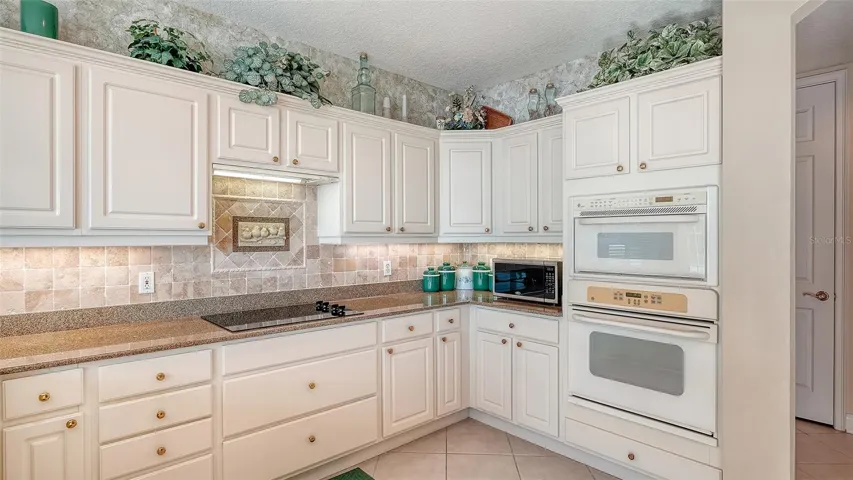 Large kitchen with a newer refrigerator and dishwasher