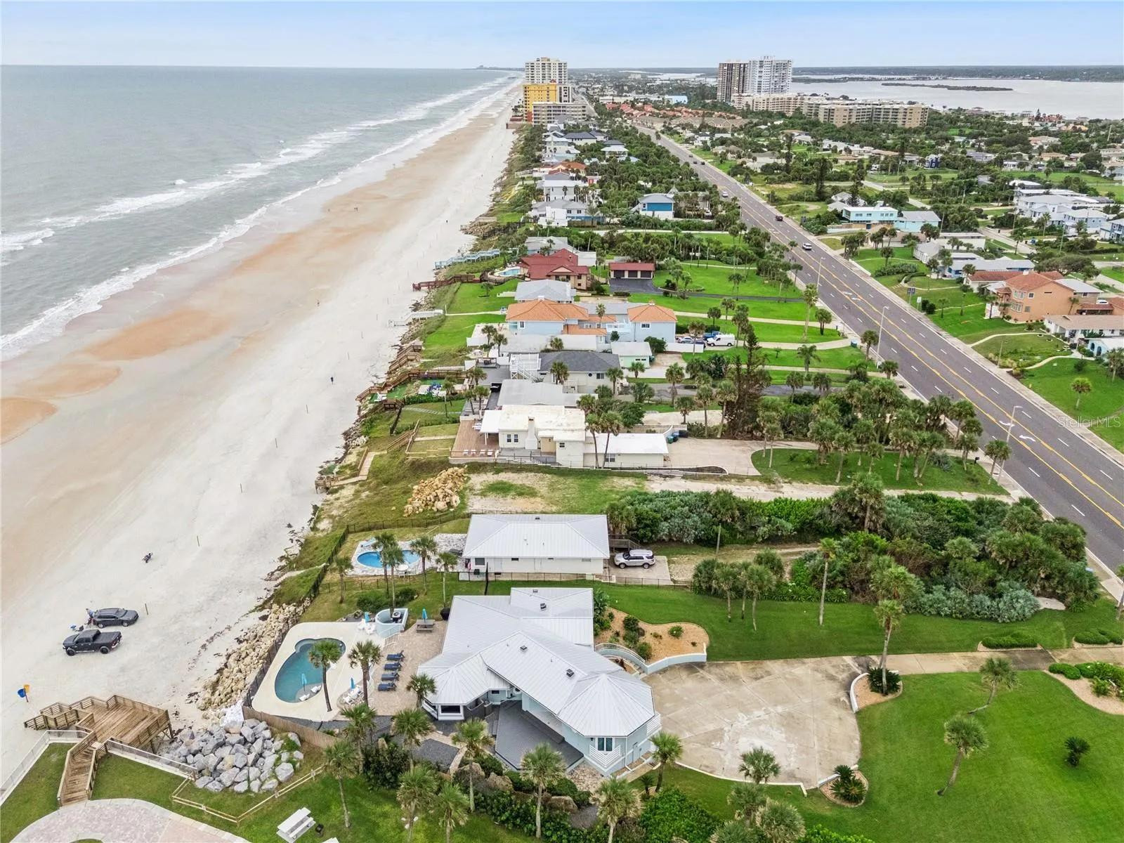 Set on over three-quarters of an acre with approximately 85 feet of ocean frontage, this property offers a generous setback from the road, ample driveway parking, and an attached garage. Neighboring Frank Rendon Park features a playground, covered picnic areas, restrooms, public beach access, and parking.
