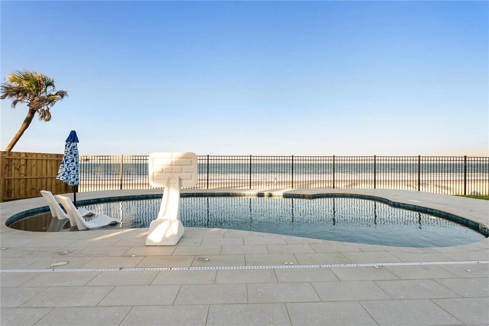 new poolNew oceanfront pool installed in 2024, featuring heating, a sun shelf, bubblers, and a 7-foot-deep end, with expansive patio space and panoramic Atlantic views.