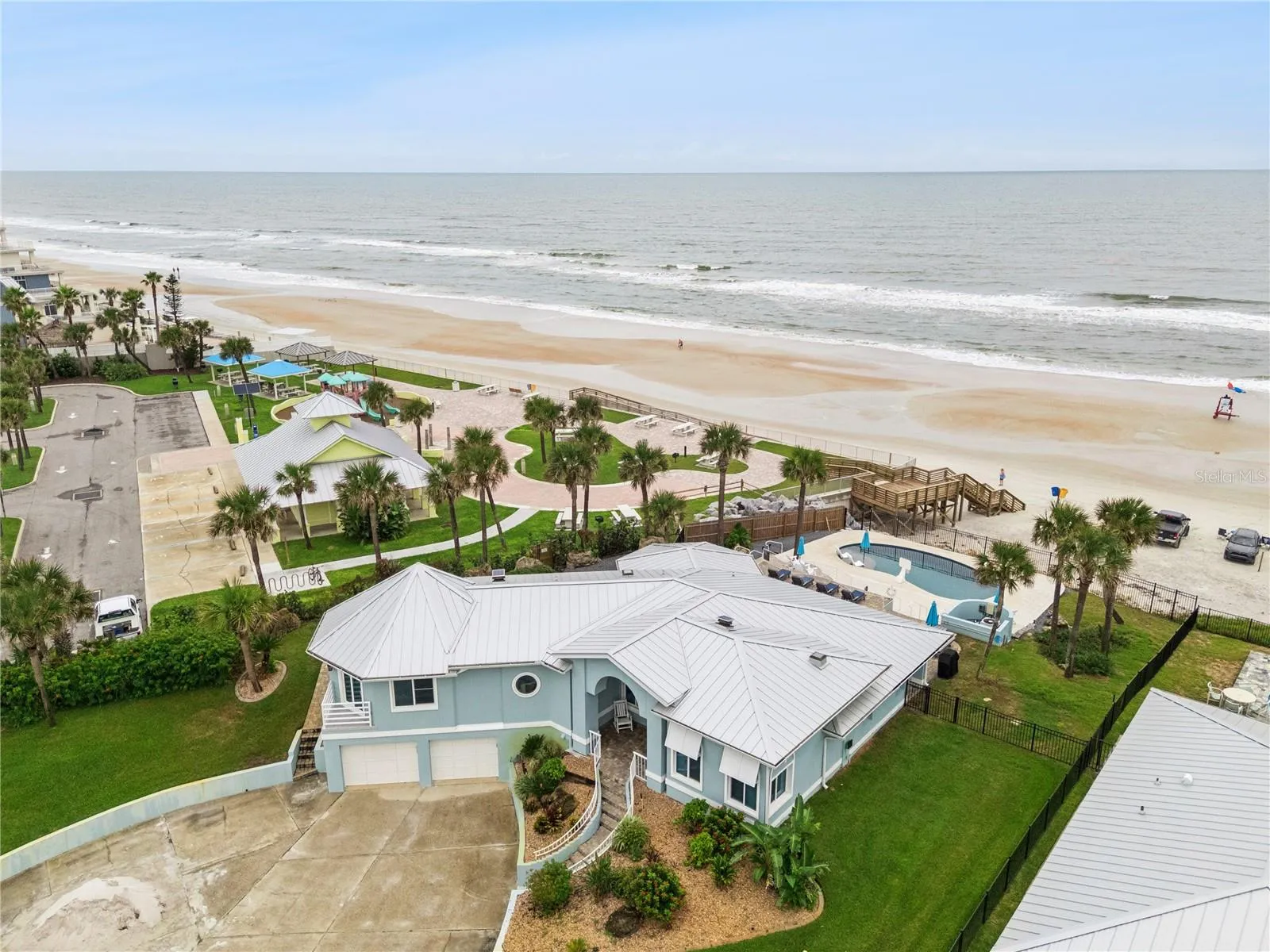 Set on over three-quarters of an acre with approximately 85 feet of ocean frontage, this property offers a generous setback from the road, ample driveway parking, and an attached garage. Neighboring Frank Rendon Park features a playground, covered picnic areas, restrooms, public beach access, and parking.