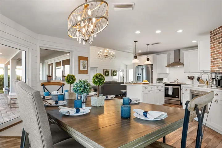 Sweeping Atlantic views take center stage in this bright family room, complemented by coastal furnishings and luxury vinyl plank flooring.