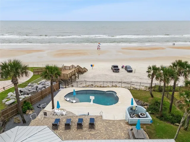 new poolNew oceanfront pool installed in 2024, featuring heating, a sun shelf, bubblers, and a 7-foot-deep end, with expansive patio space and panoramic Atlantic views.