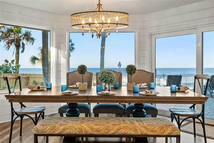 Spacious eat-in kitchen with stainless steel appliances, quartz countertops, breakfast bar seating, and beautiful ocean views—an inviting setting for casual meals and gathering.