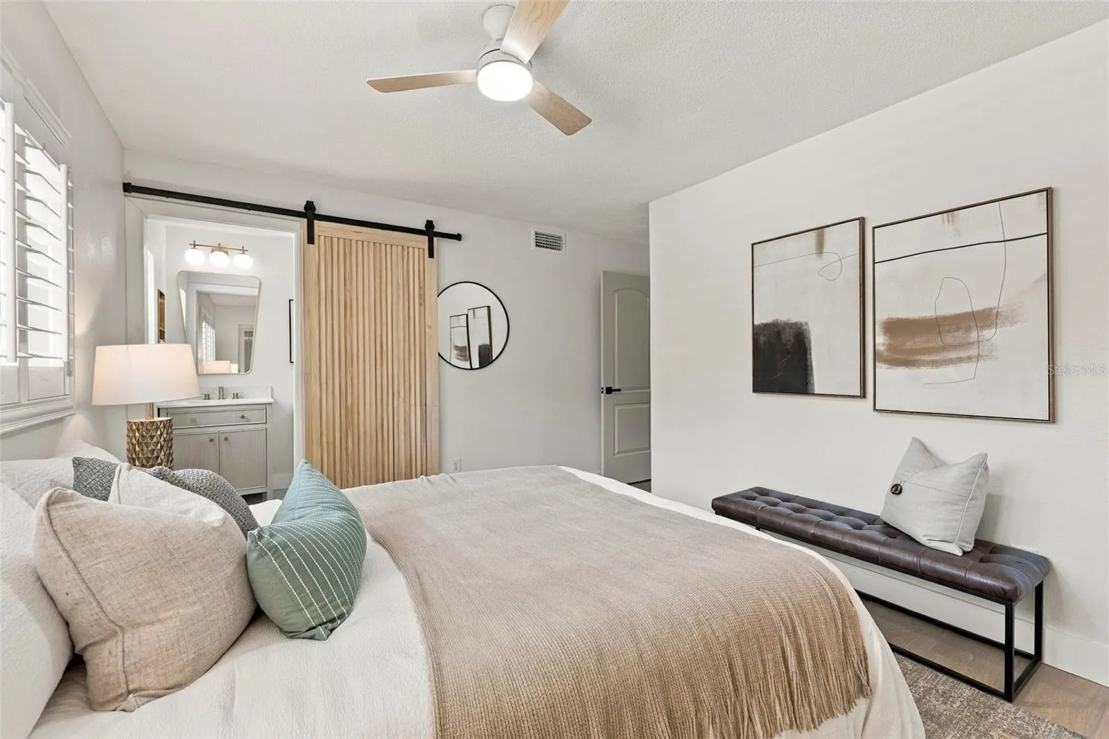 Spacious Primary bedroom with barn door entry to en suite bathroom