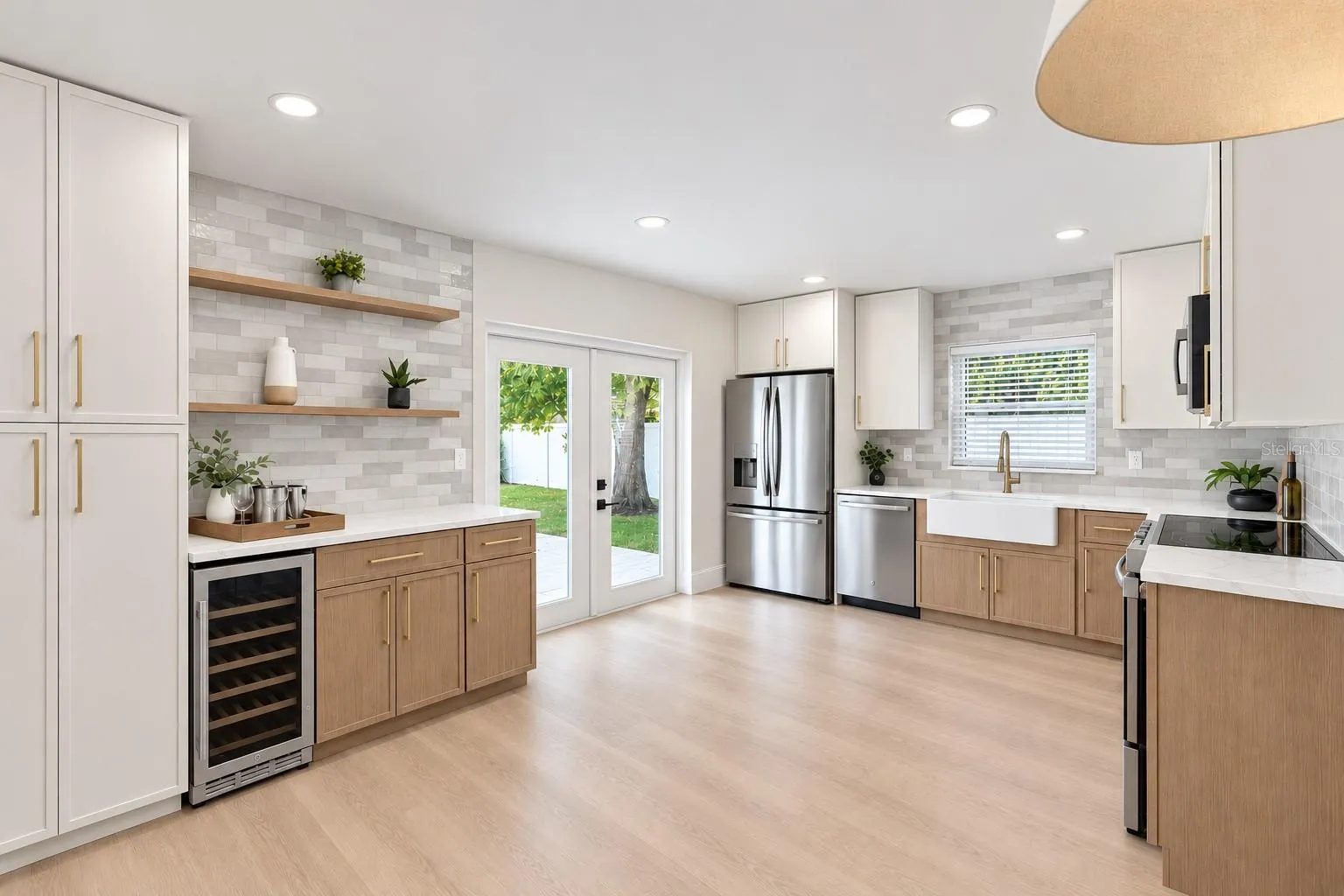Designer kitchen with two-toned slim shaker cabinets, ss appliances including beverage cooler and closet pantry