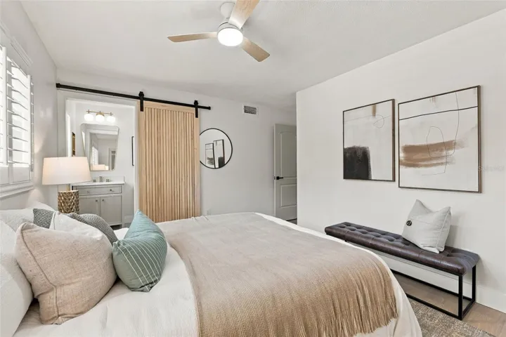Spacious Primary bedroom with barn door entry to en suite bathroom