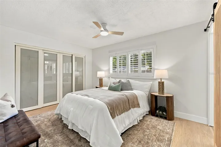 Spacious Primary bedroom with large wall closet and plantation shutters