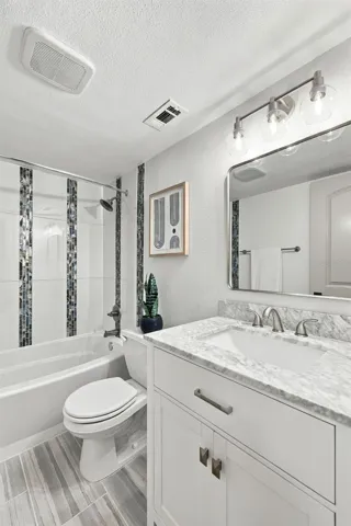 Hall bathroom with Marble vanity and updated shower/tub combo