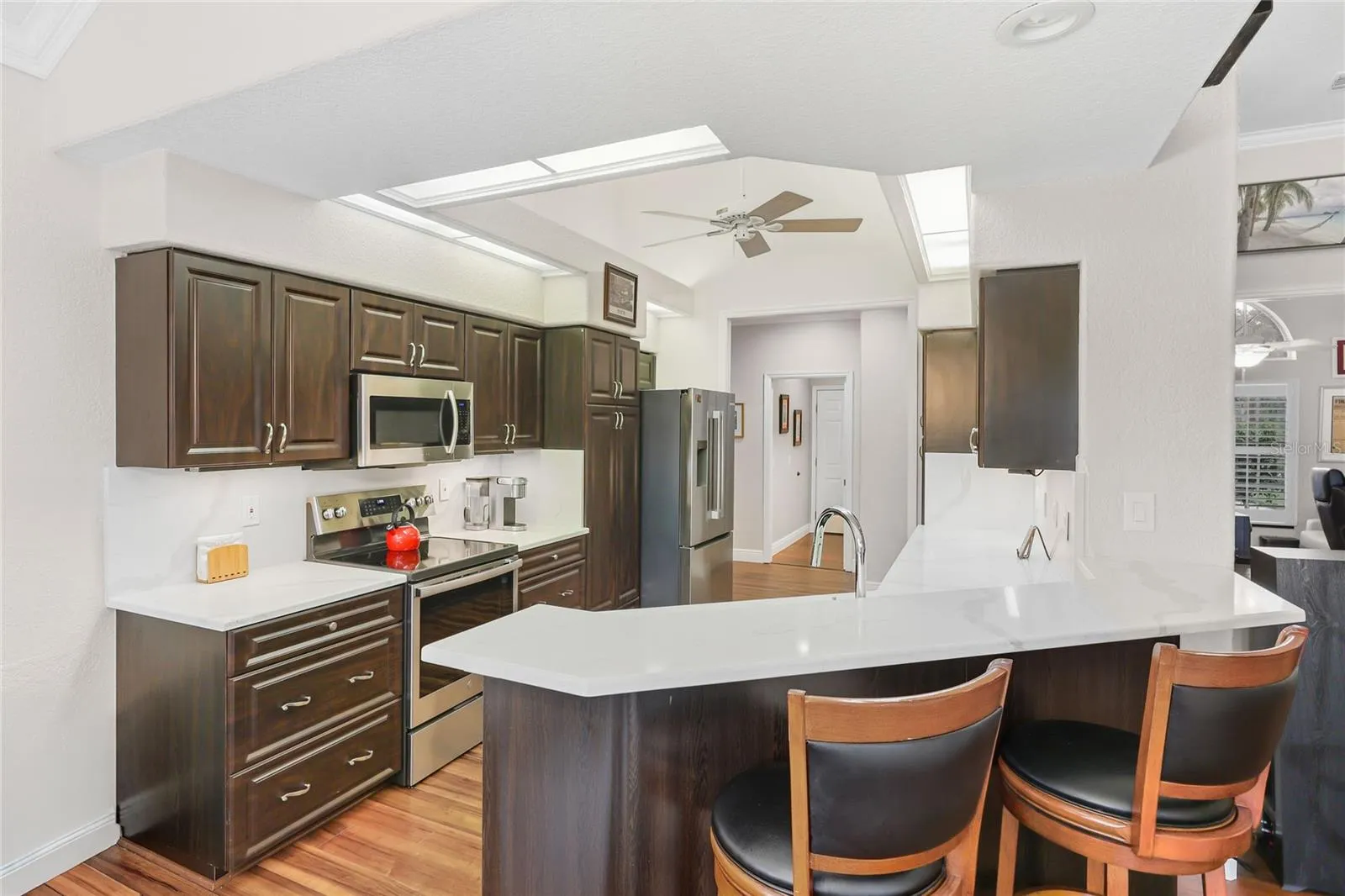 The updated kitchen sparkles with new quartz countertops and backsplash,