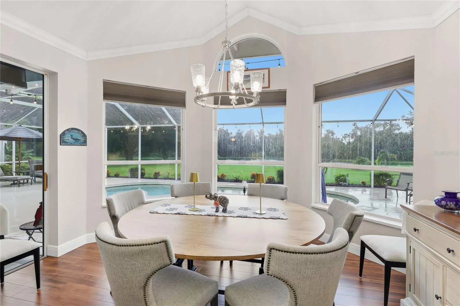 Florida dining room poolside with a lake view