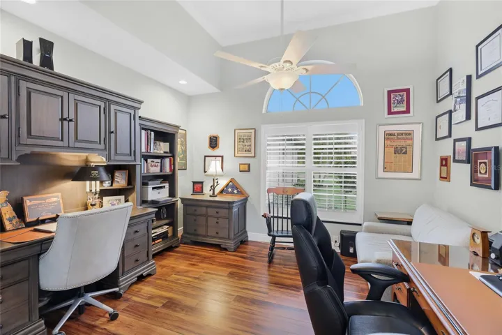 Dedicated office with high ceilings, crown molding, and luxury vinyl plank flooring