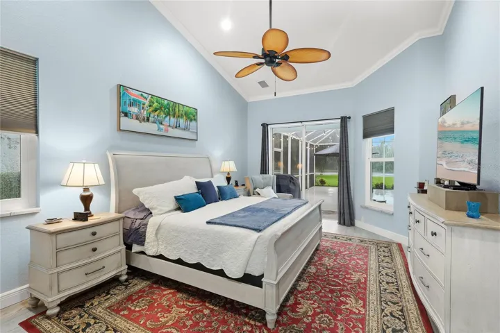 Poolside primary suite with high ceilings and crown molding