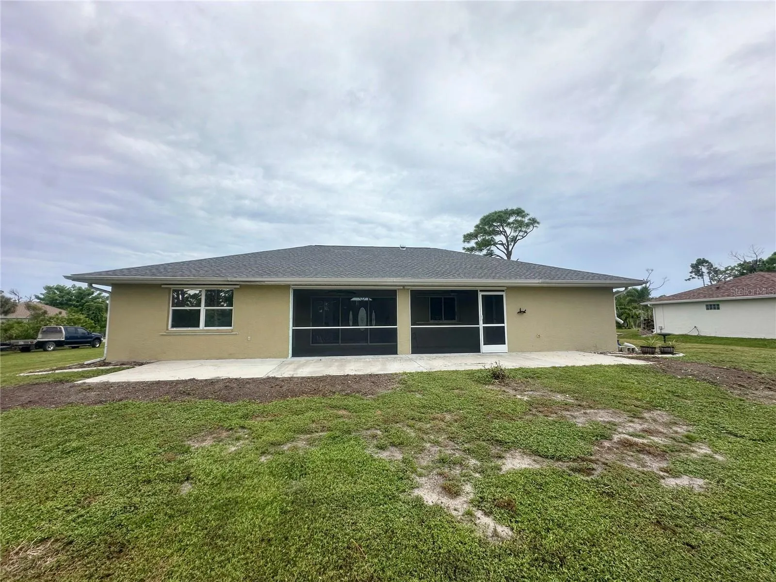 Exterior rear view. grass has been started to replace the former overgrown plantings.