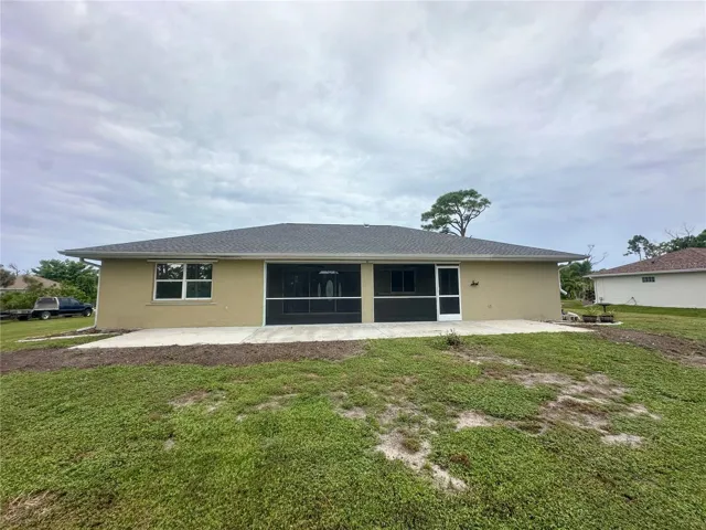Exterior rear view. grass has been started to replace the former overgrown plantings.