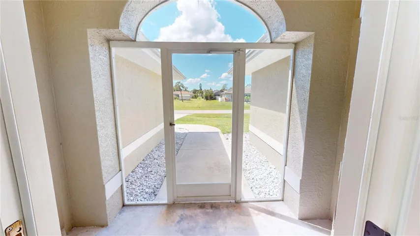Enclosed screen front porch is perfect for sitting outdoors yet indoors and watching the nature that passes by.