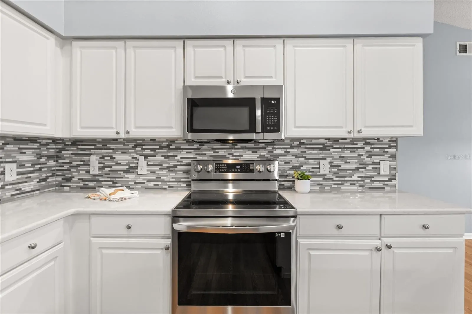 Quartz counters and tiled backsplash