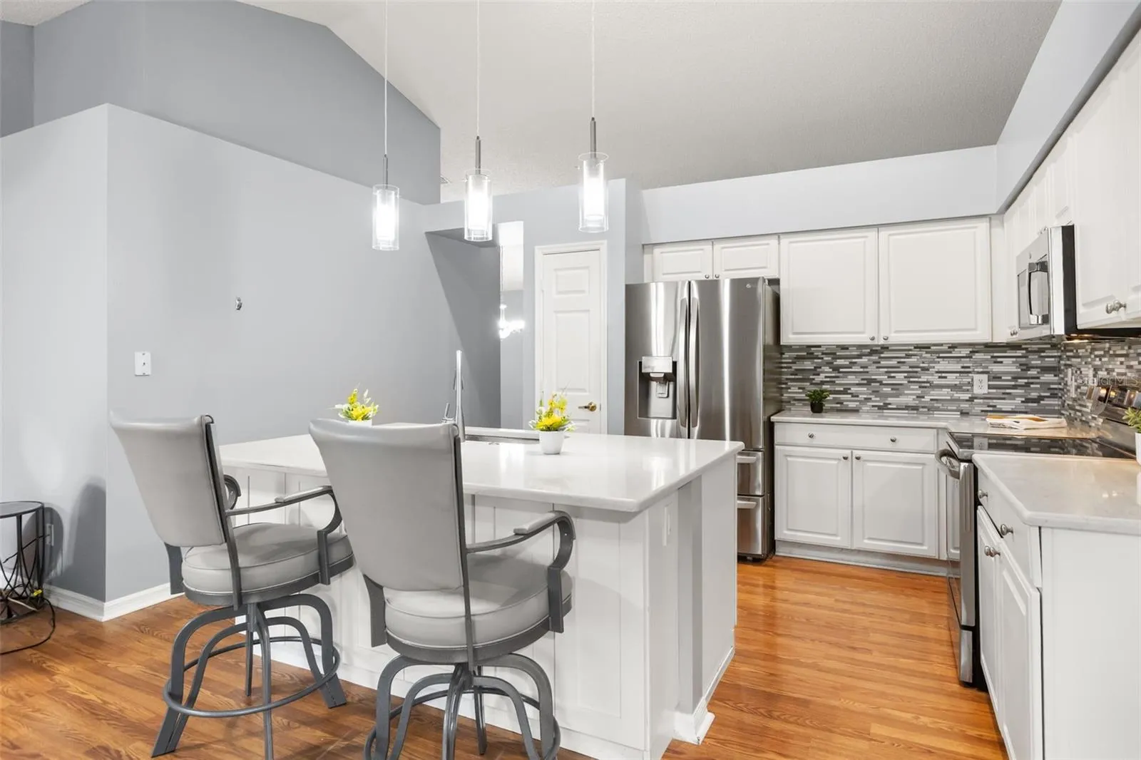 Large island for extra seating and there's cabinets for extra storage